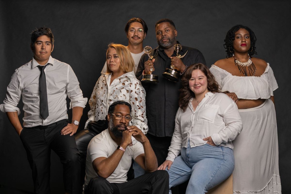 Artist and activist Senghor Reid (center, holding the Emmys) with the production crew.