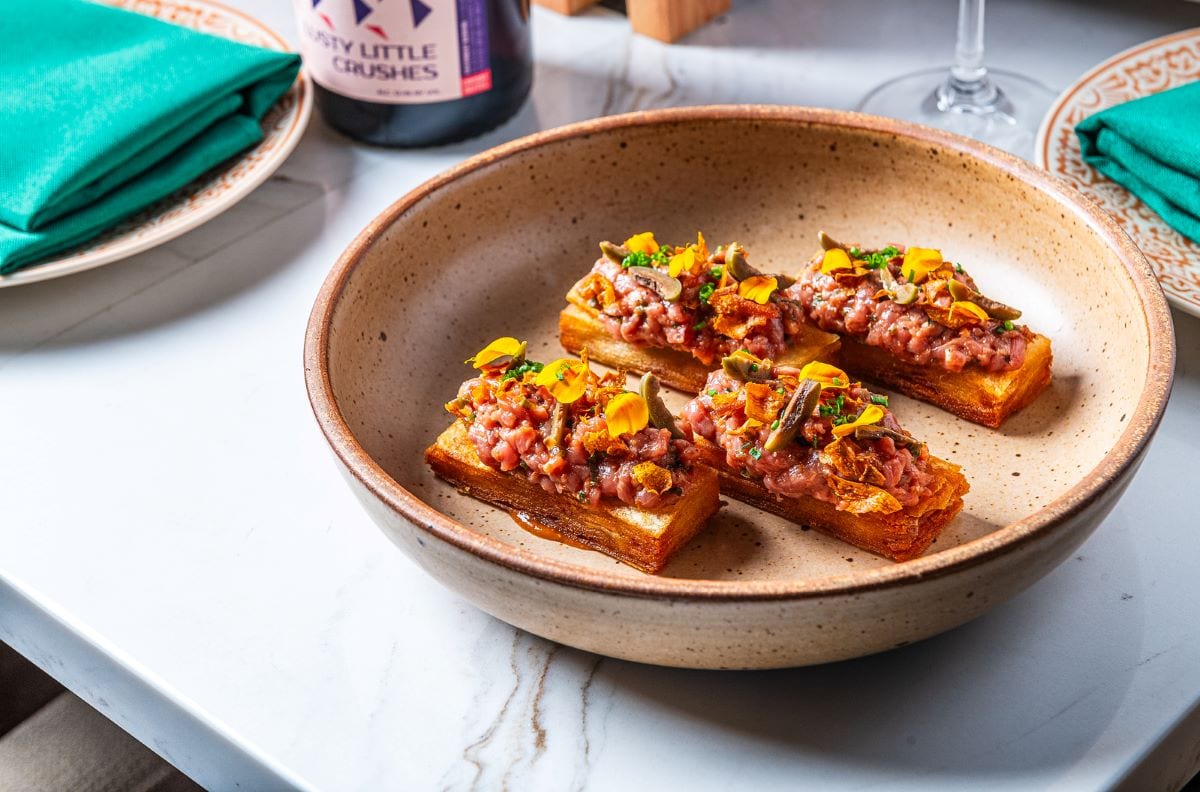 KALDERETA TARTARE WITH POTATO PAVE, CASTELVETRANO OLIVES, SMOKED TOMATO.