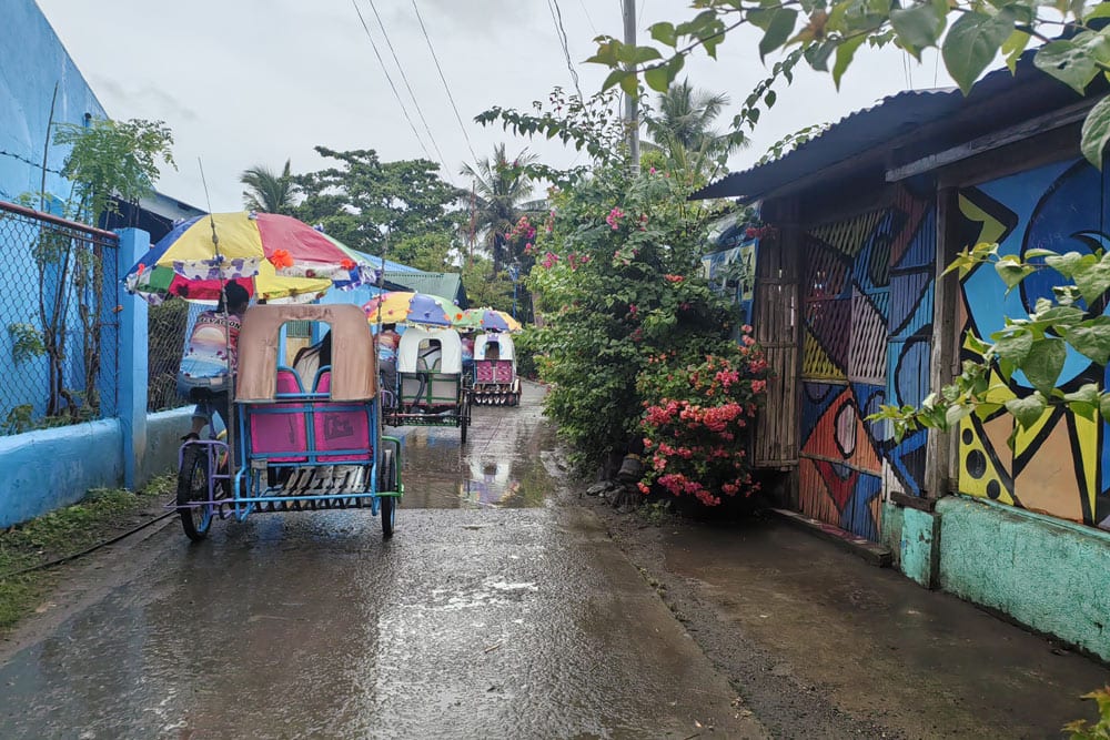 The short Trisikad tour will take you to rows of houses painted with colorful artwork