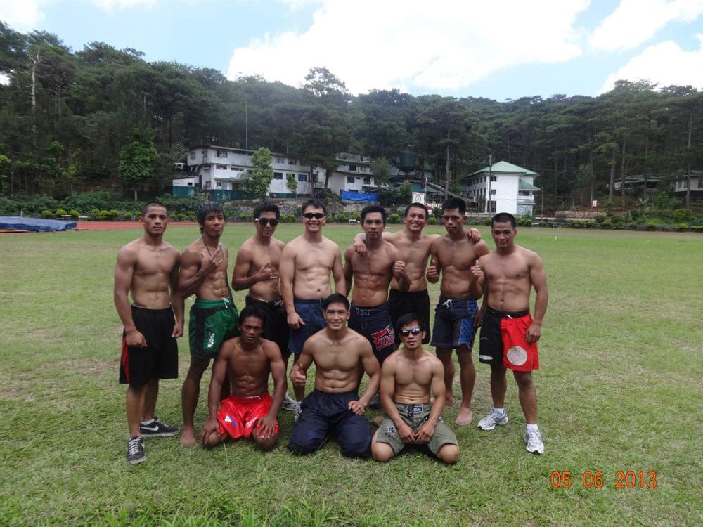 Coach Mark (standing, 4th from left) poses during training with Team Lakay at Baguio’s Teachers’ Camp