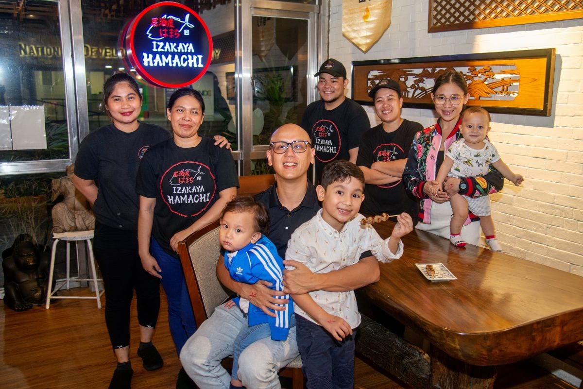 Kian and Nikole with their kids and some of Izikaya's kitchen and waitstaff