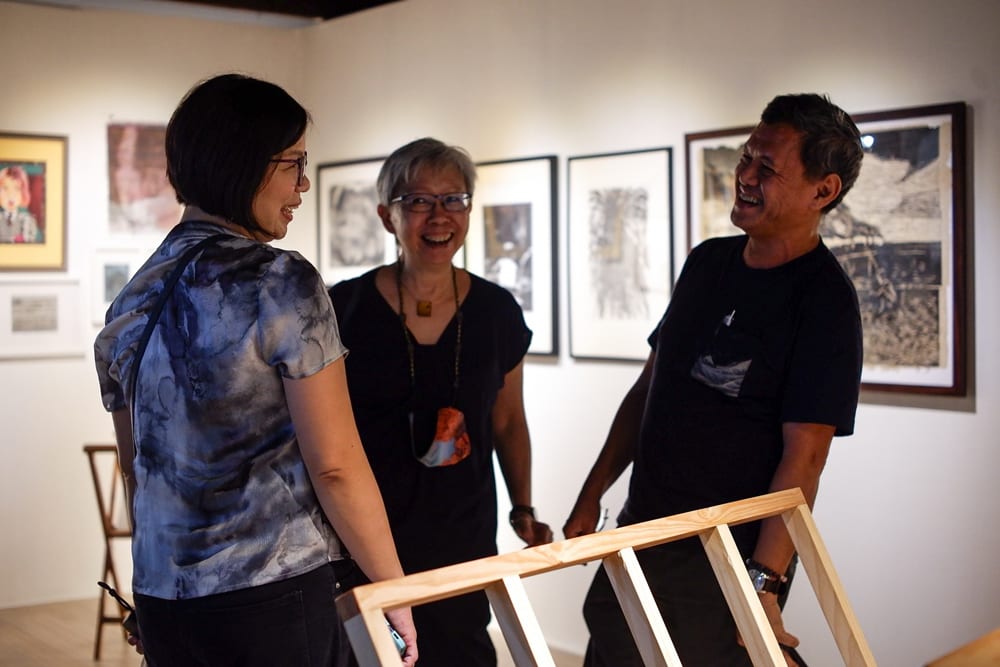 Printmakers (L-R) Melai Arguzon, Angela Silva, and Elmer Borlongan share a laugh